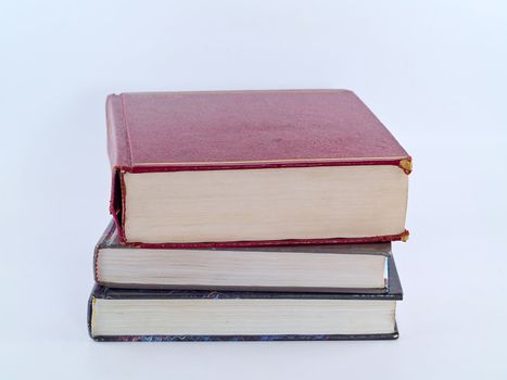 Old Textbooks stacked on a blank background