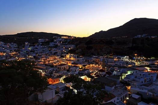 Looking over the rooftops of Lindos village at twilight