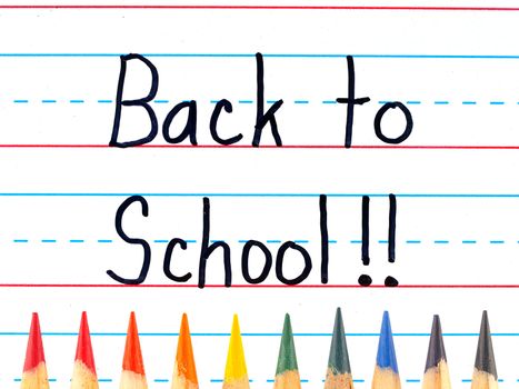 Back to School Written on a Lined Dry Erase Board with Colored Pencils