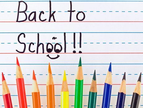 Back to School Written on a Lined Dry Erase Board with Colored Pencils