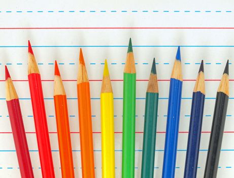 Rainbow of Colored Pencils Isolated on Lined Paper