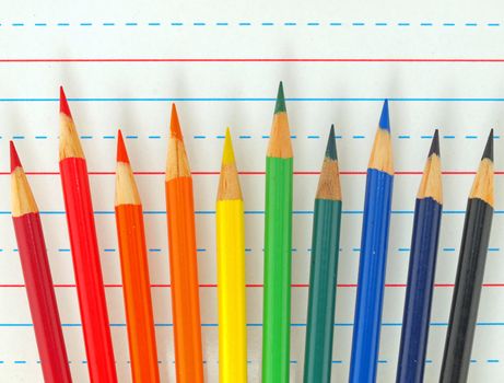 Rainbow of Colored Pencils Isolated on Lined Paper