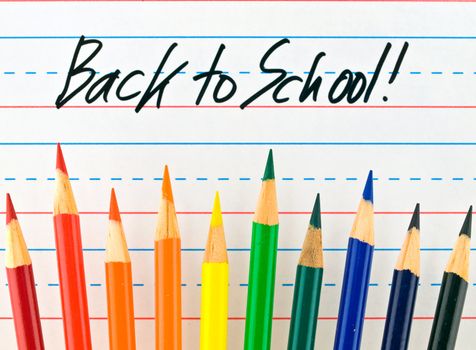 Back to School Written on a Lined Dry Erase Board with Colored Pencils 