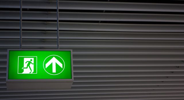 Emergency exit sign in modern offices inside an industrial plant