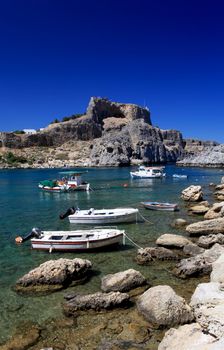 Beautiful St Pauls Bay shadowed by the temple and castle ruins at Lindos 