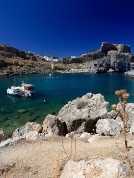 Beautiful St Pauls Bay shadowed by the temple and castle ruins at Lindos 