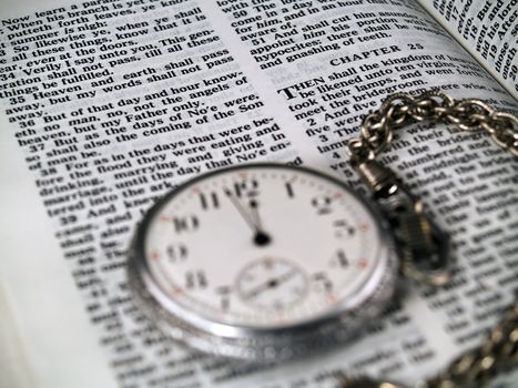 The Bible opened to Matthew 24: 36 with a Pocketwatch