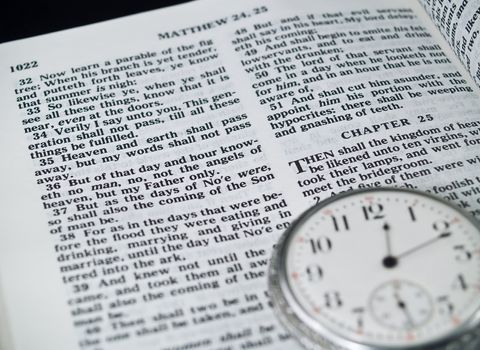 The Bible opened to Matthew 24: 36 with a Pocketwatch