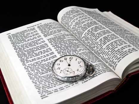 The Bible opened to Matthew 24: 36 with a Pocketwatch