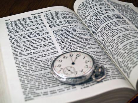 The Bible opened to Matthew 24: 36 with a Pocketwatch