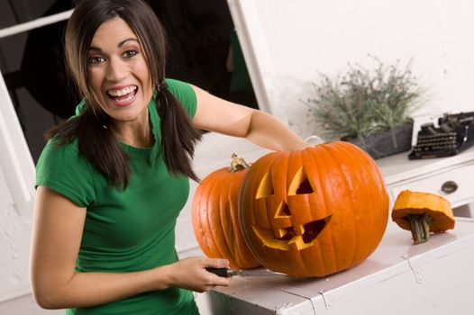 A house wife gets a kick out of carving the pumpkin for Halloween