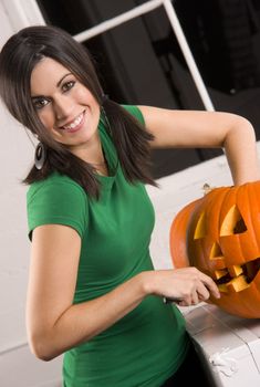 A house wife carves the pumpkin for Halloween