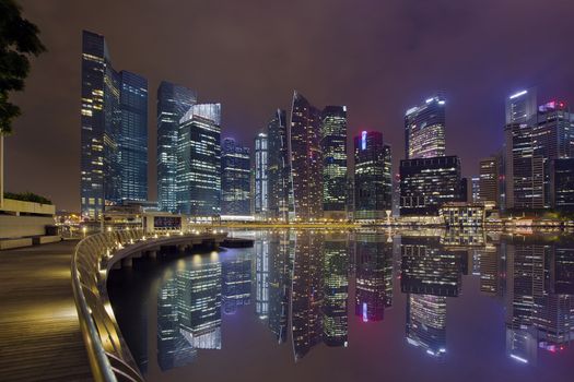 Singapore Central Business District City Skyline Along Marina Bay Boardwalk at Night