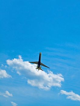 A Commercial Airliner Taking Off into a Partly Cloudy Blue Sky