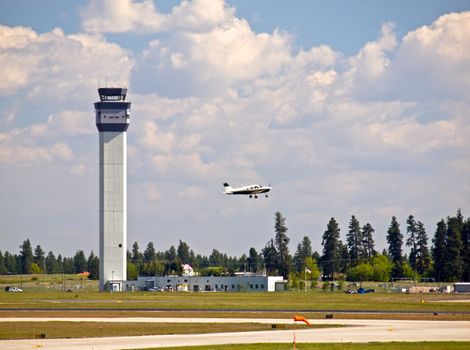 Air Traffic Control Tower of a Modern Airport with Aircraft Taking Off