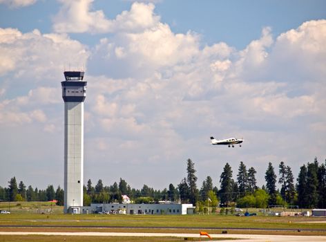 Air Traffic Control Tower of a Modern Airport with Aircraft Taking Off