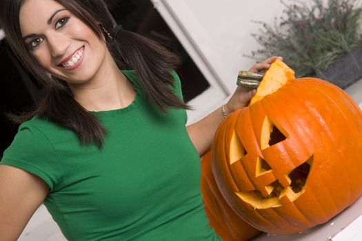 A house wife gets a kick out of carving the pumpkin for Halloween