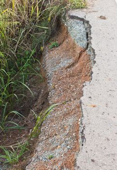 Road crack because of water erosion.
