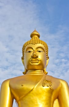 Golden Buddha statue in a Buddhist temple and blue sky