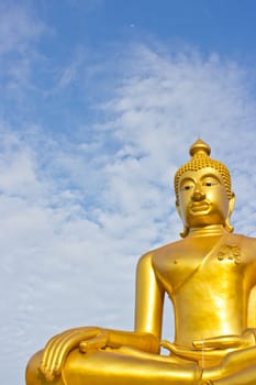 Golden Buddha statue in a Buddhist temple and blue sky