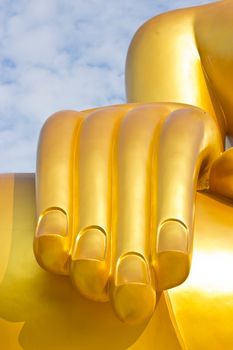 Hand golden Buddha statue in a Buddhist temple