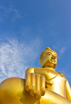 Golden Buddha statue in a Buddhist temple and blue sky
