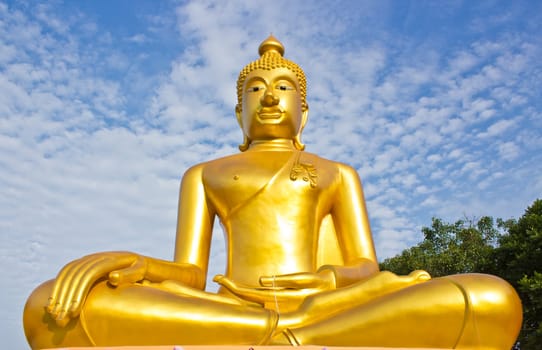 Golden Buddha statue in a Buddhist temple and blue sky
