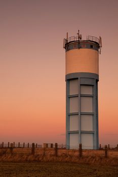 Historic water reservoir brick tower at sunset