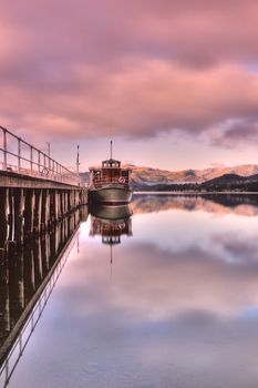 Scenic view of boats moored by wooden pier , Lake District National Park, England.
