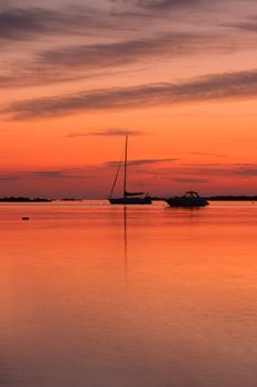 Yachts near the Tavolara island on the golden sunrise over the sea - Sardinia - Italy