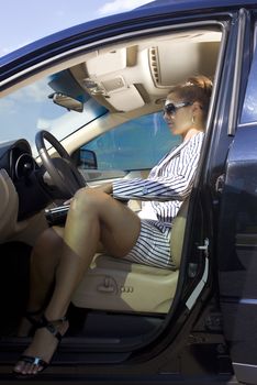 beautiful smart businesswoman sits in the premium car