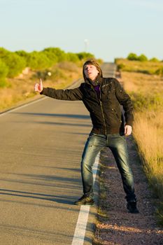 Hitchhiking youngster quite desperate to get a lift