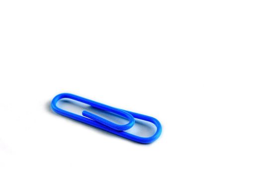 Blue paperclip on white background