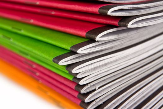 Stack of color notebooks on white background