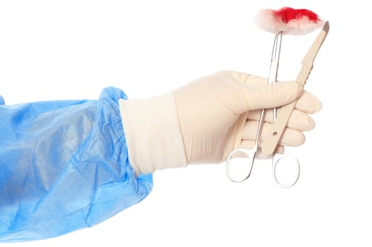 scalpel and clamp with swab in the hand of the surgeon during a surgery