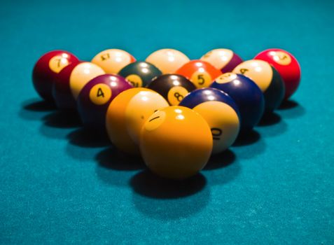 Billiards balls on a green pool table