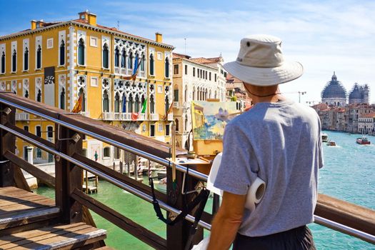 An artist painting a beautiful picture on a bridge in Venice, Italy