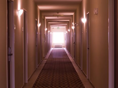 Empty hotel corridor in monochrome pink color tone