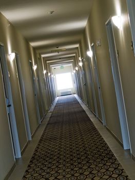 Empty, crooked hotel corridor in monochrome sepia color tone