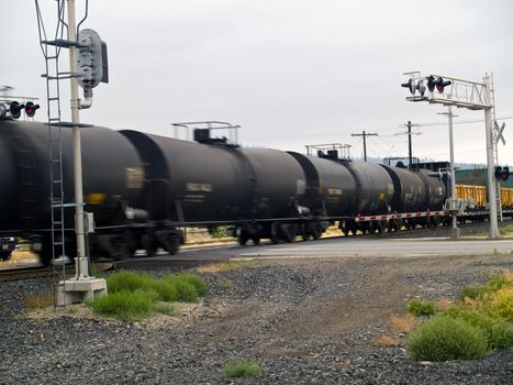 Blurred moving cargo trains from a train road crossing