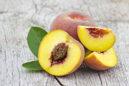 Fresh peaches on old wooden background
