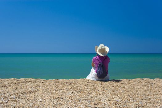 girl sitting at the edge of the sea