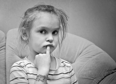 little thoughtful girl looking at the camera