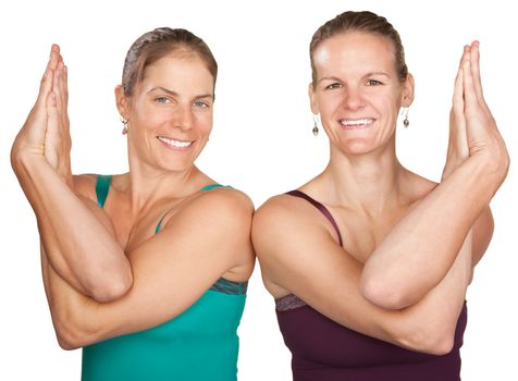 Two women perfrom namaskar with hands twisted