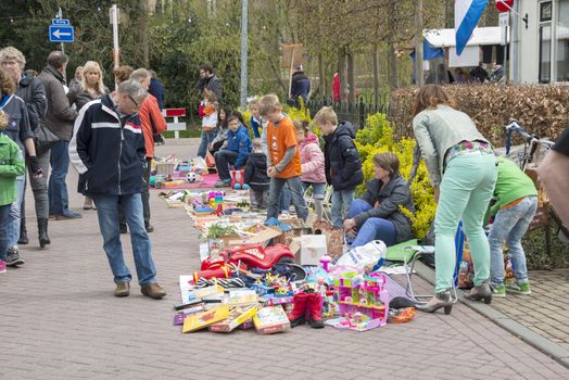 DIRKSLAND,HOLLAND - APRIL 30 unidentified people shopping on the market in the streets during the celebration of queensday on April 30, 2013 in Dirksland, The Netherlands