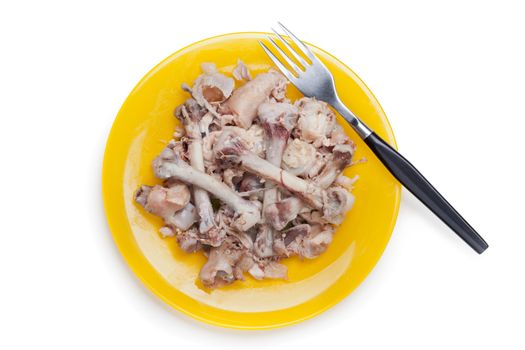 Food leftovers - chicken meat bones heap on plate white isolated