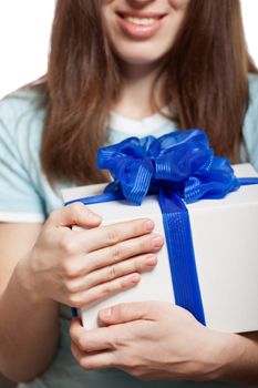 Smiling woman hand holding blue ribbon wrapped holiday surprise gift or present box package