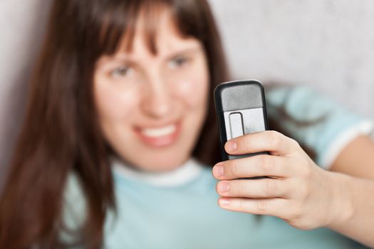 Smiling woman hand holding mobile communication phone