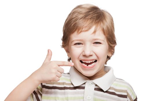 Little smiling child boy hand pointing his first baby milk or temporary tooth fall out