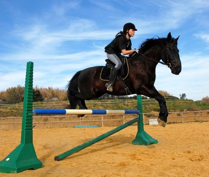 training for competition of jumping for an horse and her riding girl